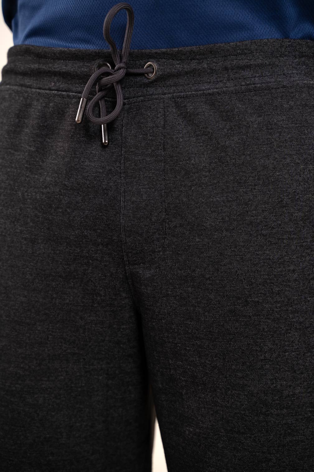 Detailed close-up of the stitching and waistband of the black joggers, showcasing their durable construction