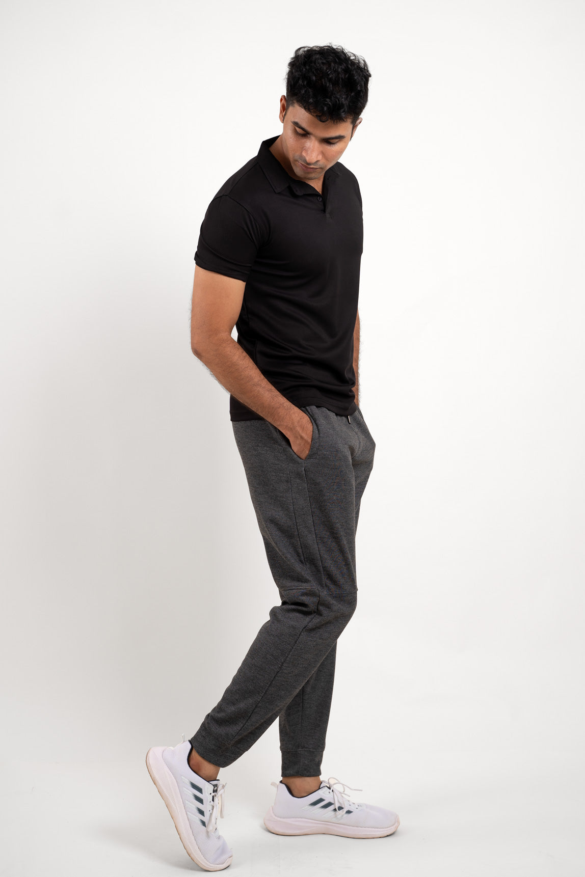 Side angle of the active black polo t-shirt, displaying its ergonomic fit and activewear appeal