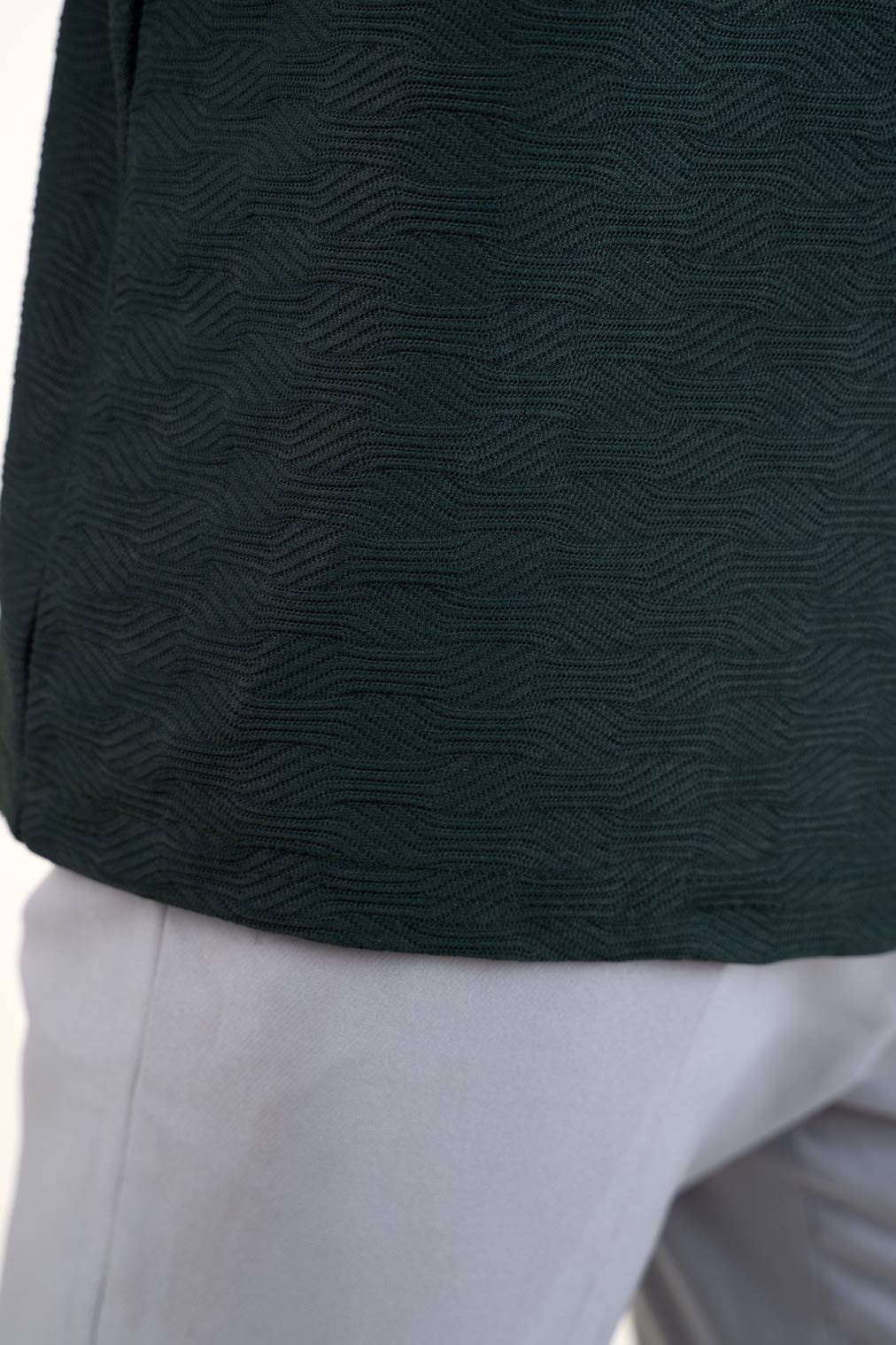 Close-up front view of man in green polo t-shirt