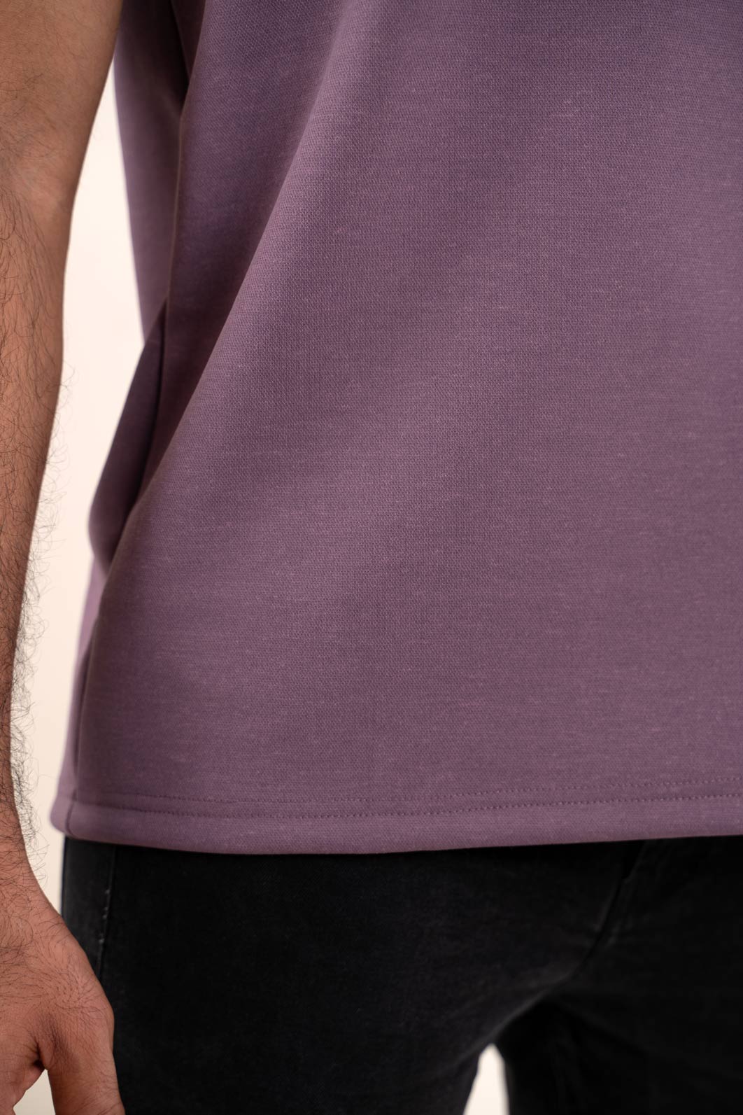 Detailed close-up of the stitching and fabric of the lavender zipper polo shirt, emphasizing its soft texture and meticulous construction