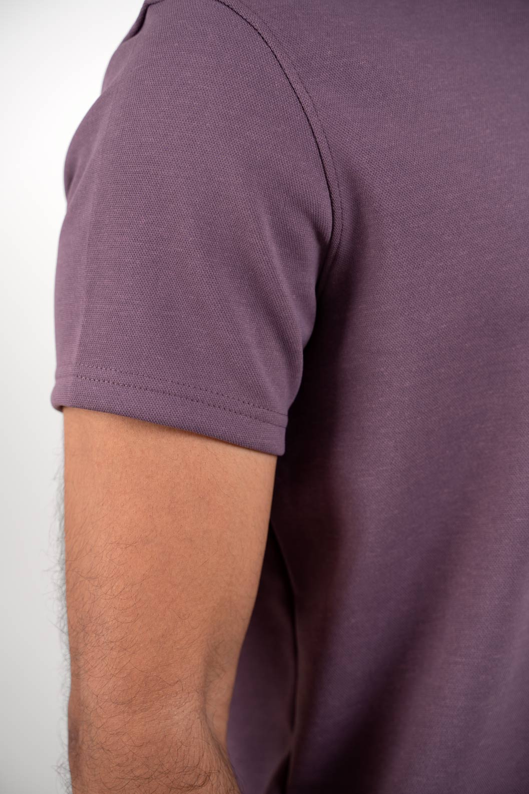 Detailed close-up of the stitching and fabric of the lavender zipper polo shirt, emphasizing its soft texture and meticulous construction