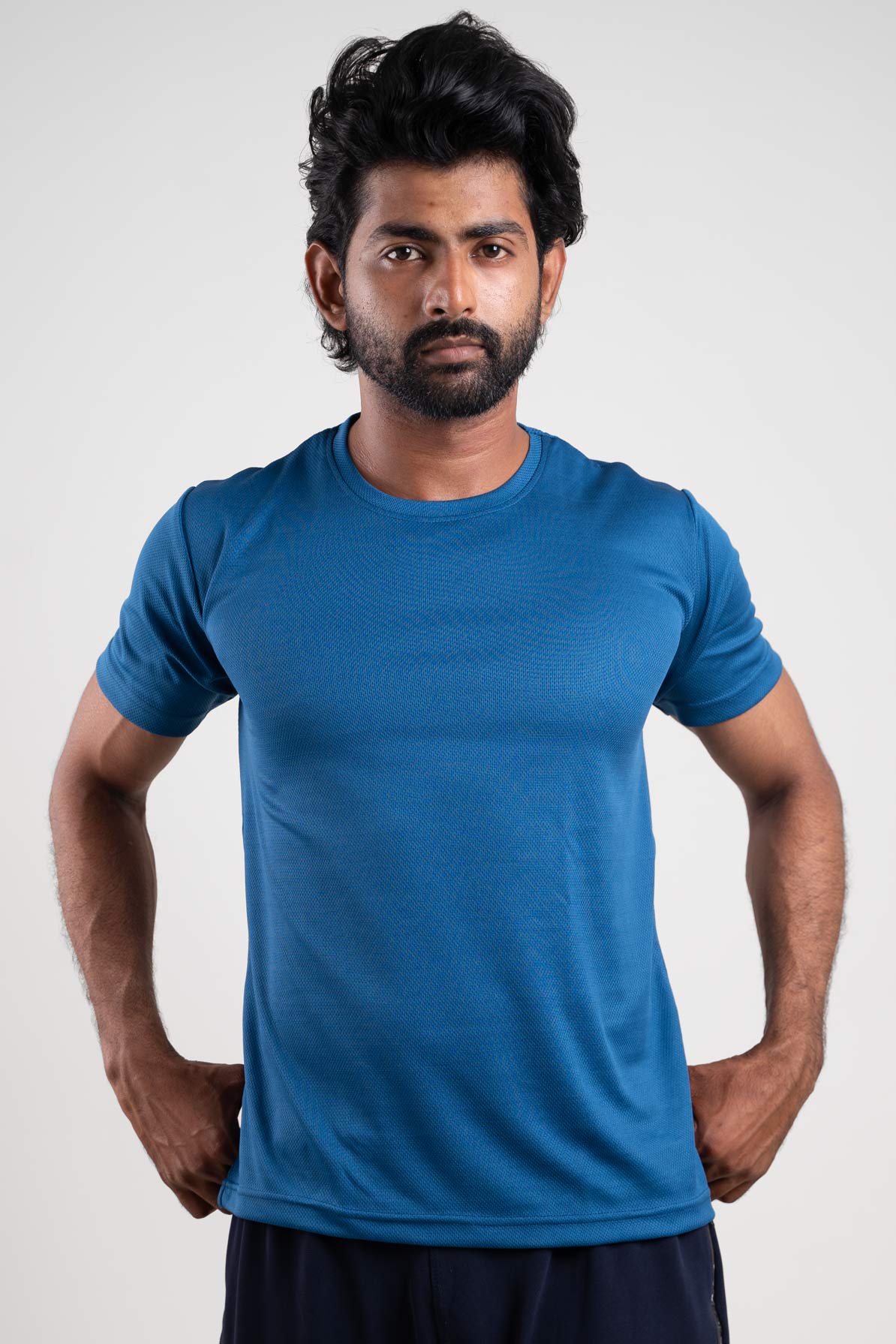 Front View of the stitching and hem of the active blue crew neck t-shirt, highlighting its durable construction