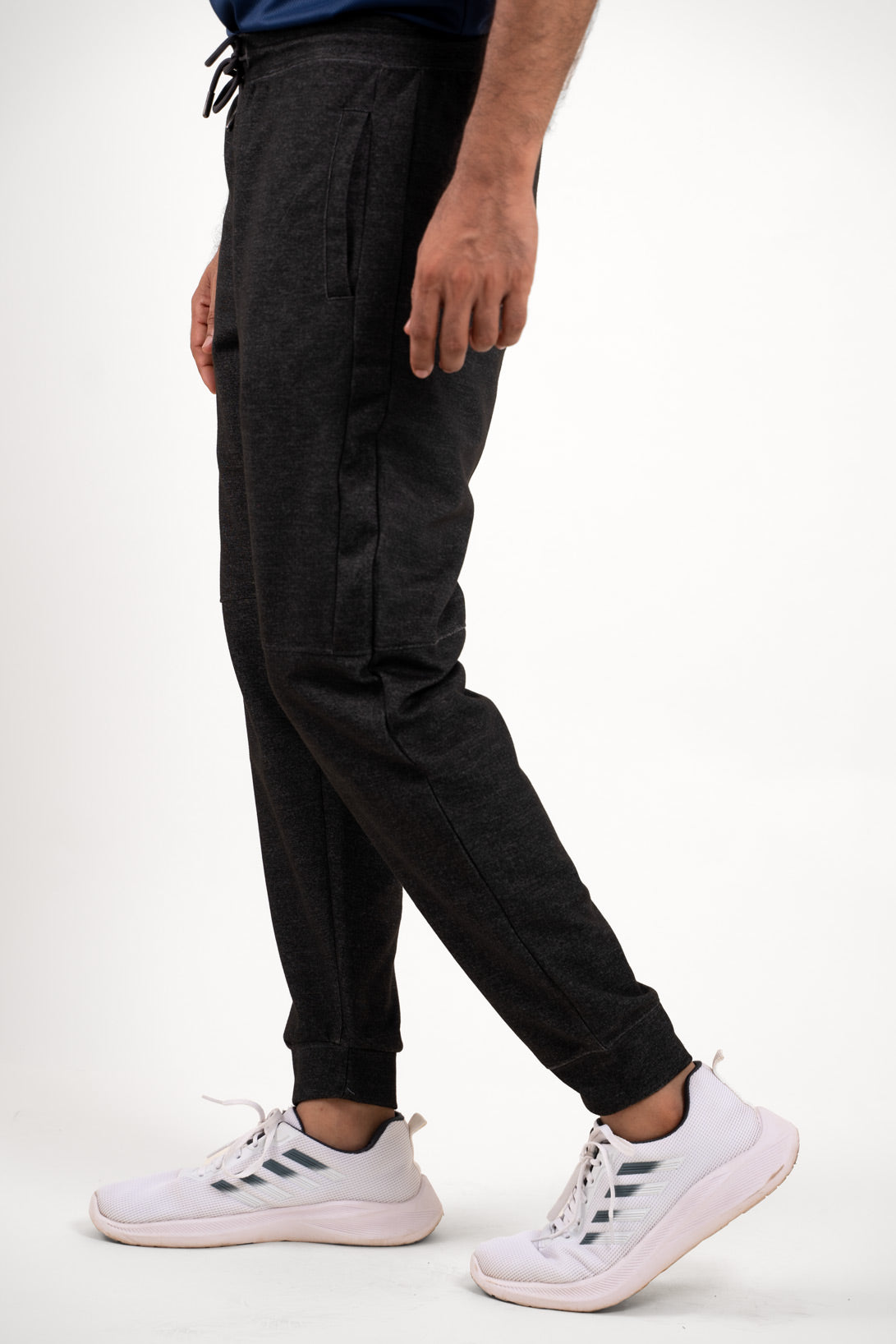 Side angle of the black joggers, displaying their athletic cut and comfortable wear