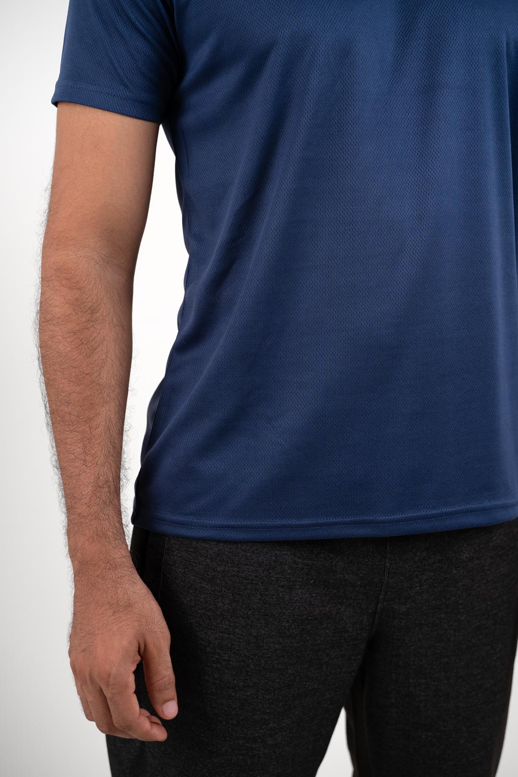Zoomed-in view of the navy blue crew neck t-shirt's stitching and hem, showcasing its durable construction