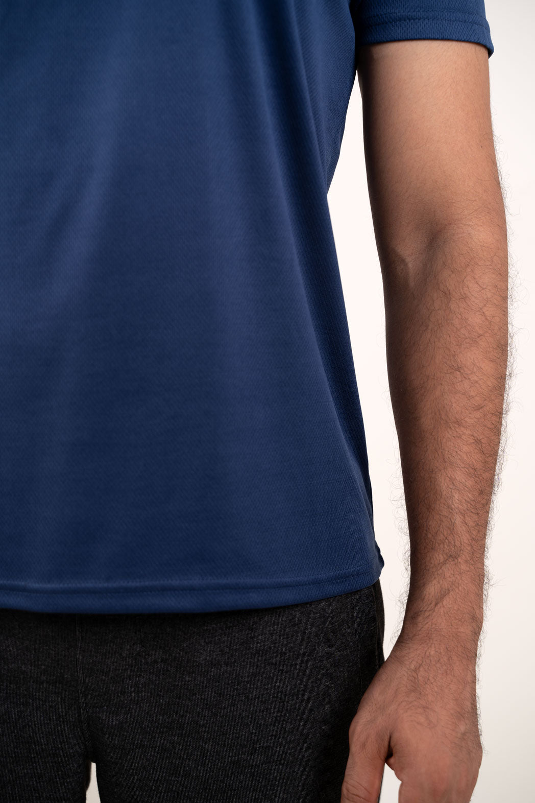 Detailed close-up of the active navy blue crew neck t-shirt's texture, highlighting its high-quality material