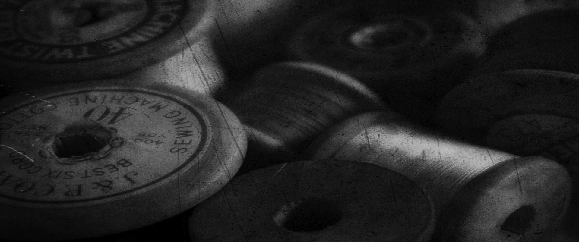 Black and white image of thread cones for fabric