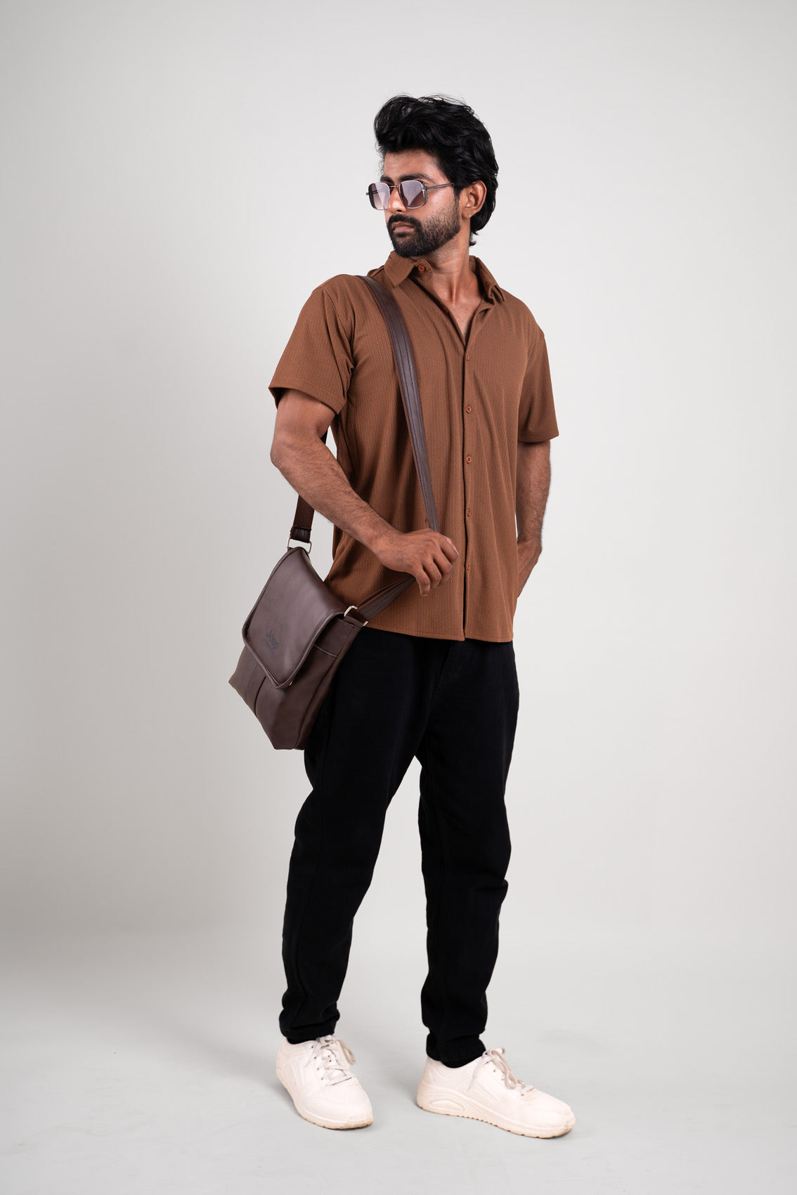 Overall view of the solid black polo t-shirt, capturing its textured sophistication and versatile appeal.