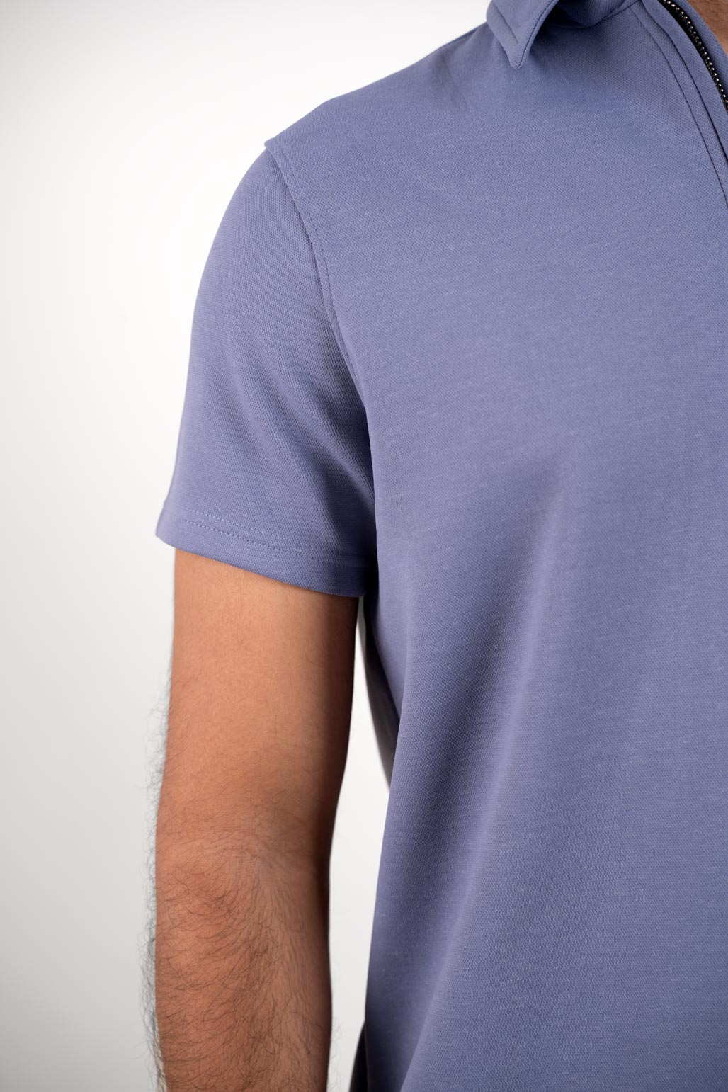 Another detailed view focusing on the hem and cuffs of the lavender zipper polo shirt, adding depth to its overall design
