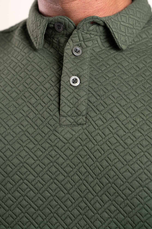 Detailed view of the collar and buttons on the green polo t-shirt, emphasizing its refined craftsmanship