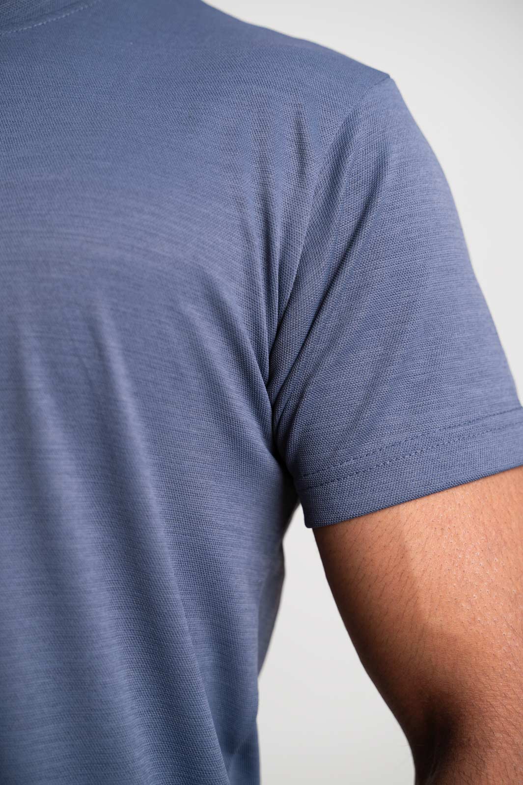 Another detailed view focusing on the sleeve cuffs and hem of the grey crewneck tee, adding depth to its design