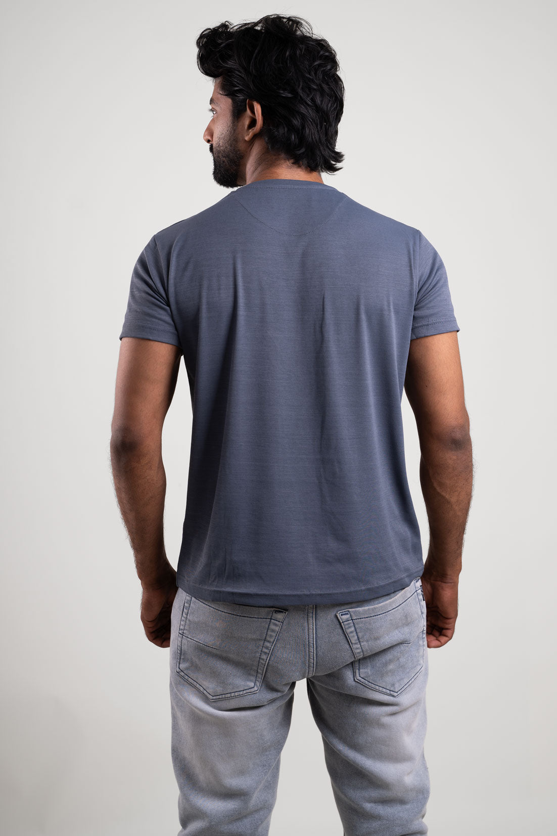 Back view of the solid grey crewneck t-shirt, emphasizing its clean lines and essential appeal