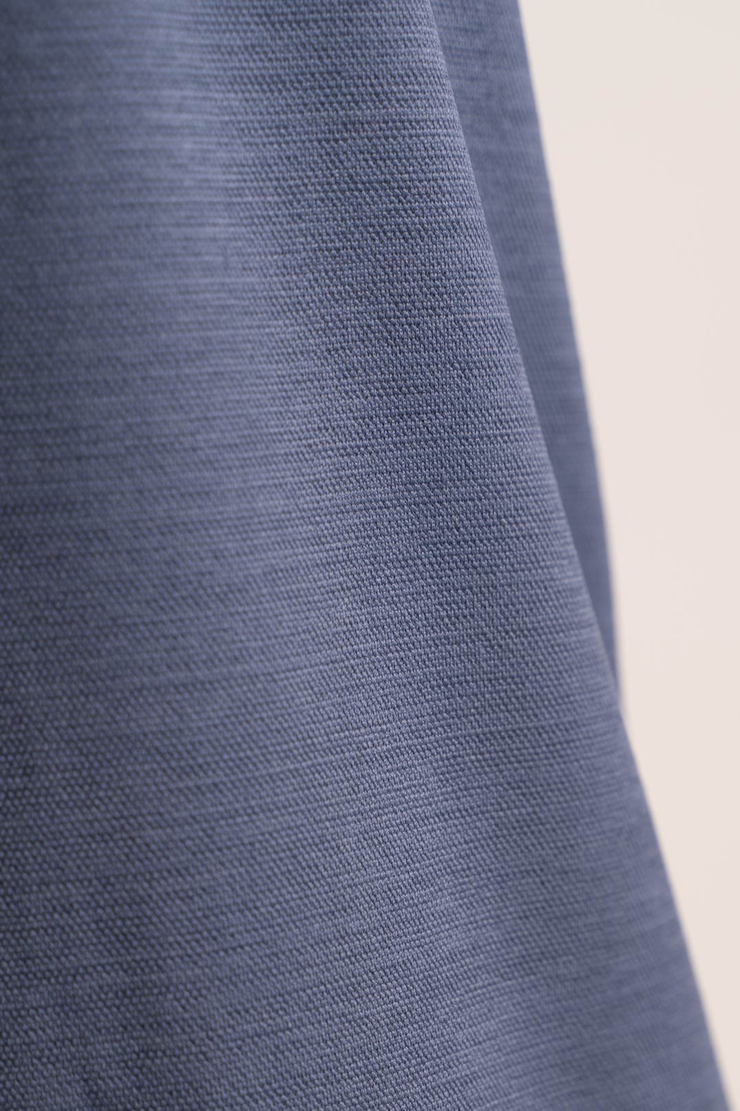 Close-up shot of the fabric of the grey crewneck t-shirt, revealing its softness and durability
