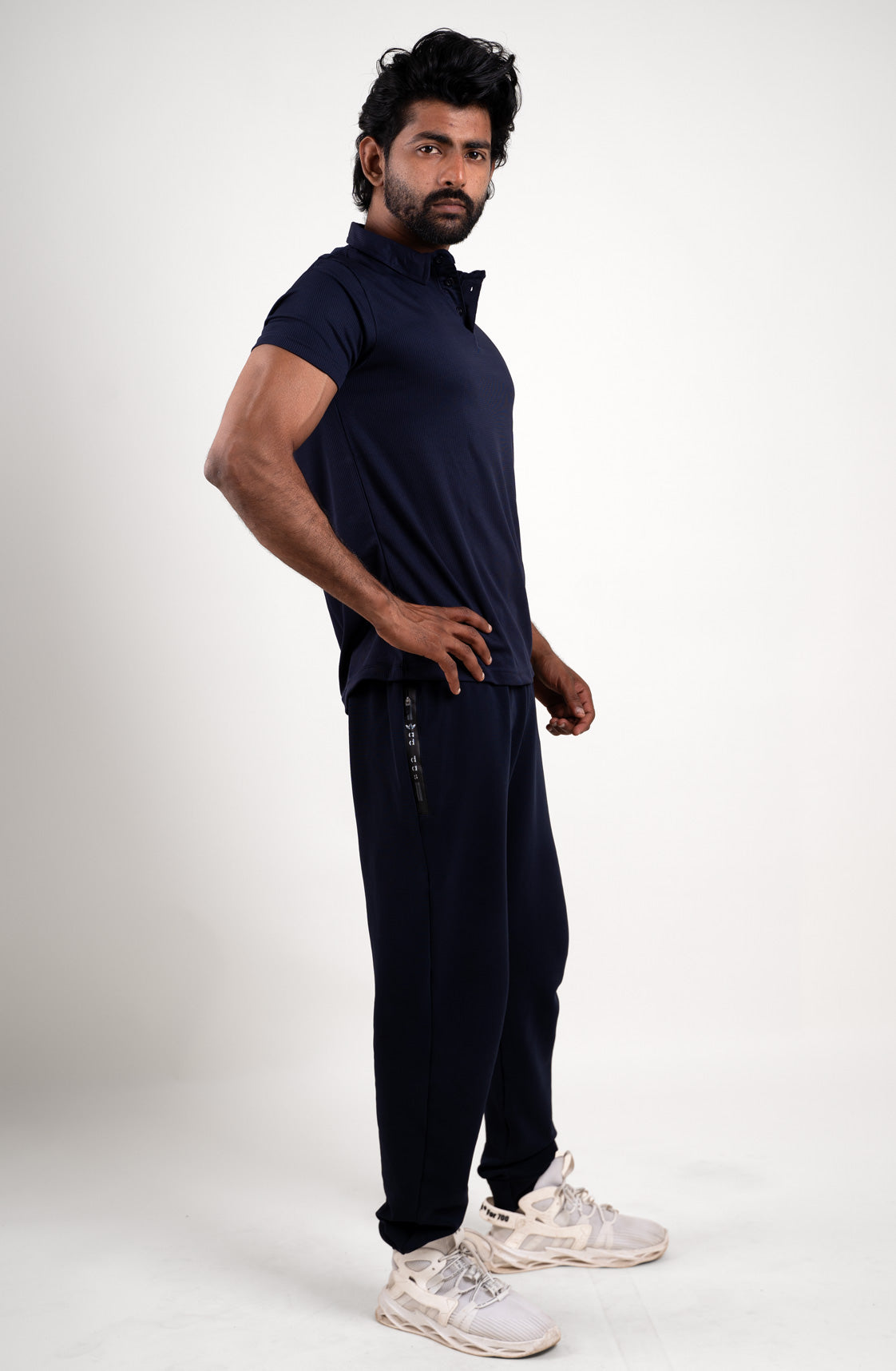 Full-length image of the active navy blue polo t-shirt, providing a comprehensive look at its overall design